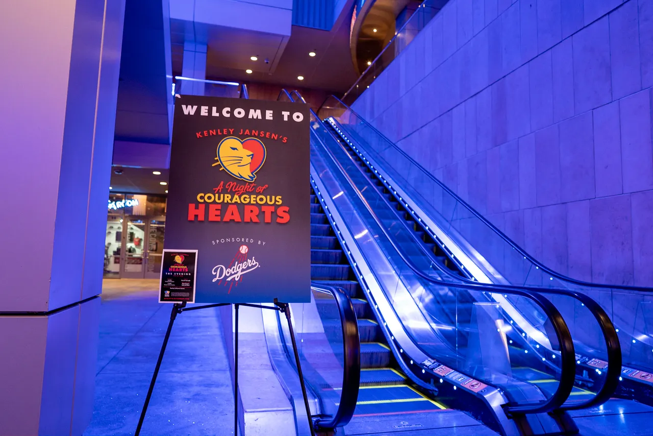 Welcome sign for an evening charity event displayed near an escalator