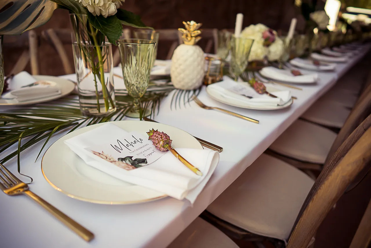 Table setting with tropical decor at a themed party