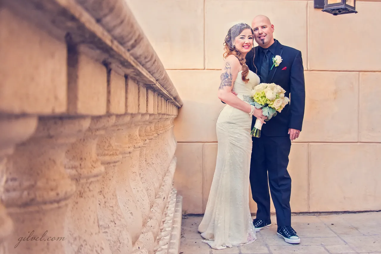 Couple embracing beside a stone balustrade